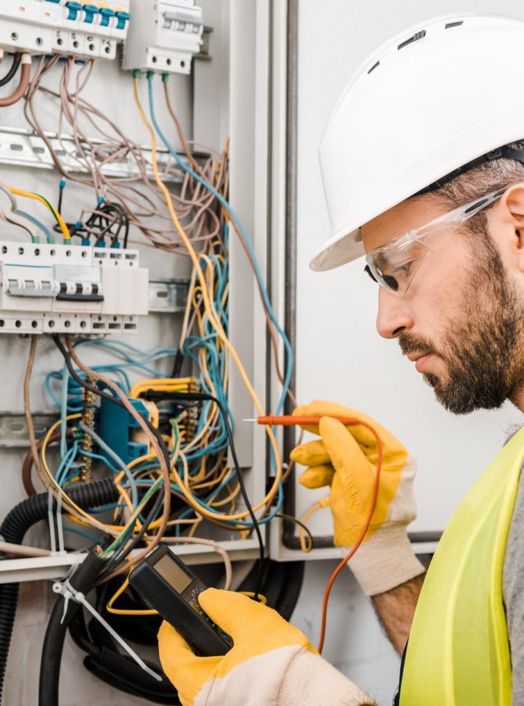 handsome-electrician-checking-electrical-box-with-multimetr-in-corridor.jpg handsome-electrician-checking-electrical-box-with-multimetr-in-corridor.jpg